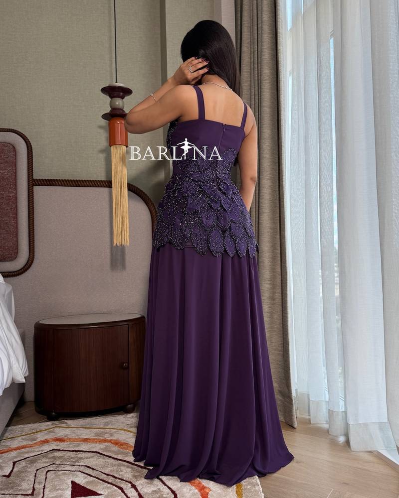 A flowing purple dress with delicate embroidery