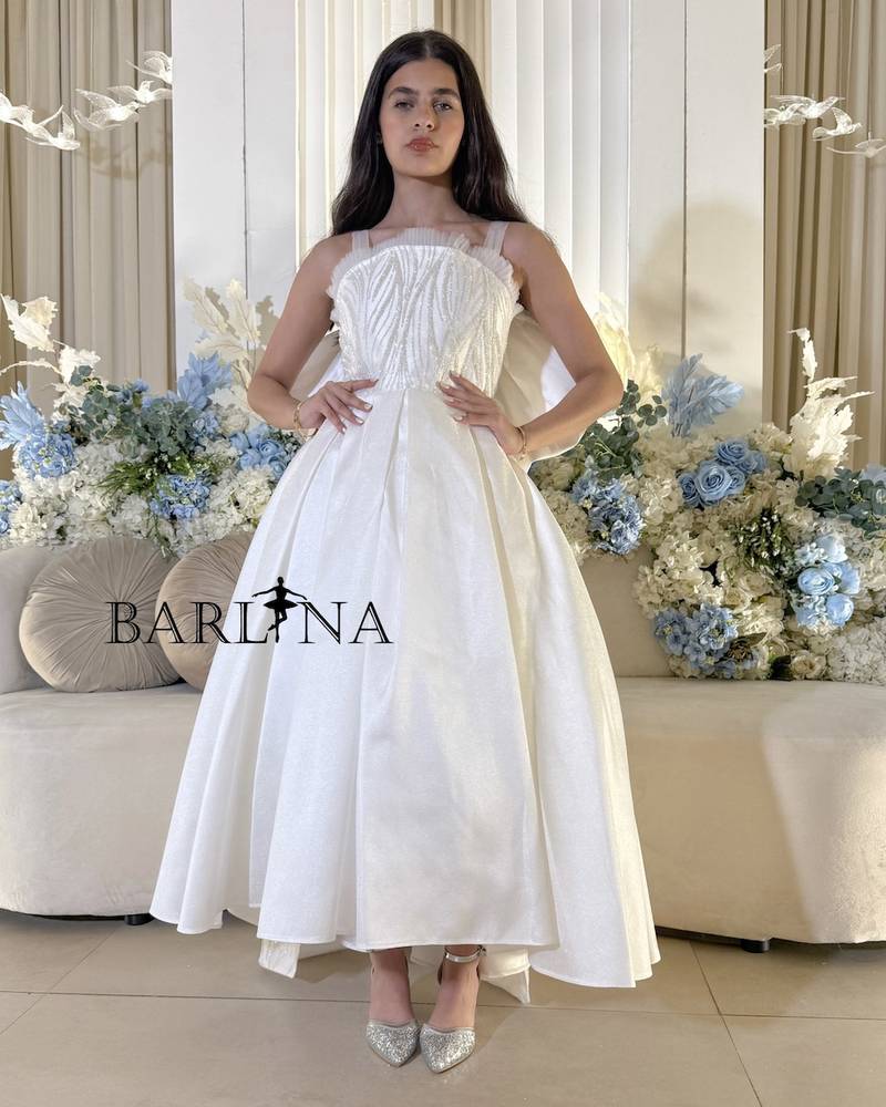 White evening dress with long bow tail