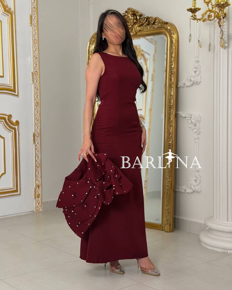 Burgundy dress with a pearl-embellished shoulder piece