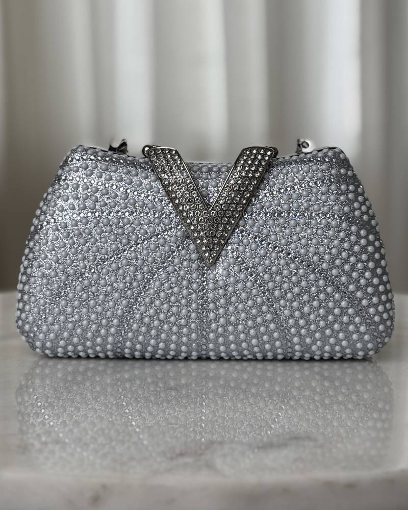A luxurious occasion bag adorned with pearls and rhinestones
