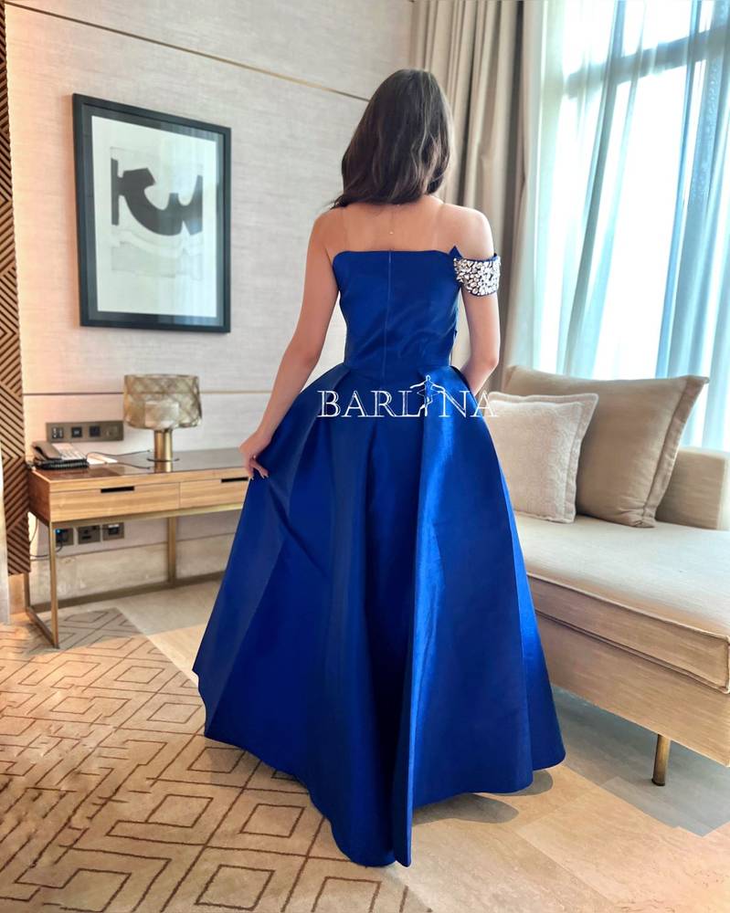 Long blue dress embroidered with crystals