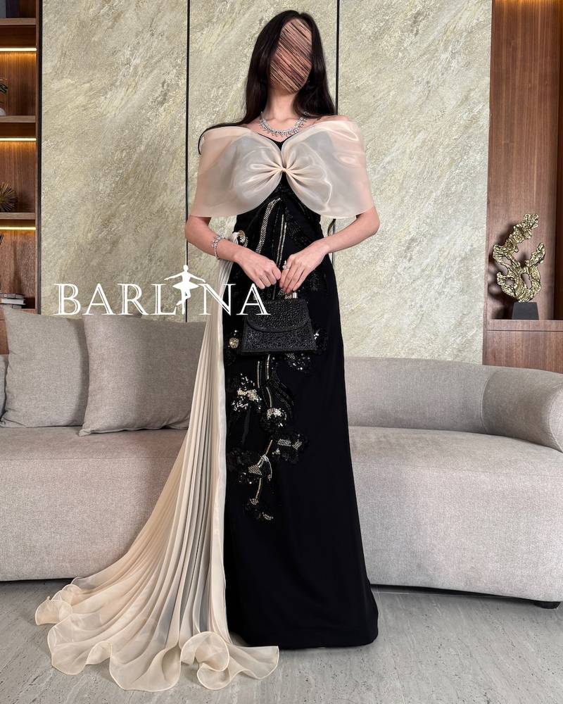 Luxurious black dress with beige shoulders and train