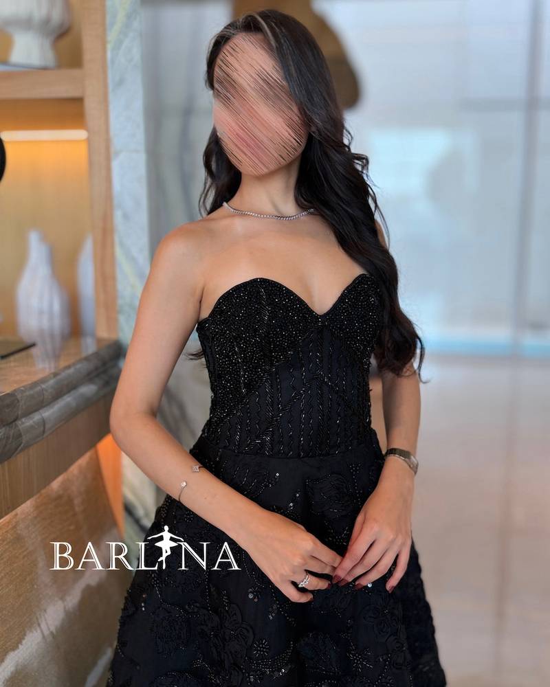 A puffy evening dress with shiny black embroidery