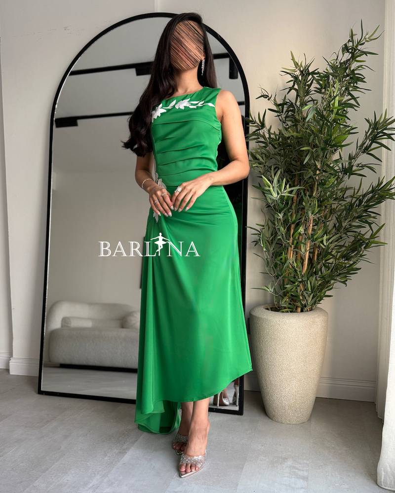 Green dress with pleated details at the waist