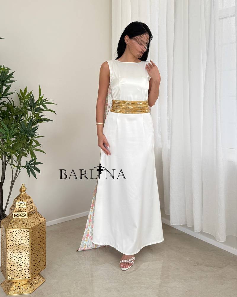 A soft white jalabiya with a gold embroidered belt