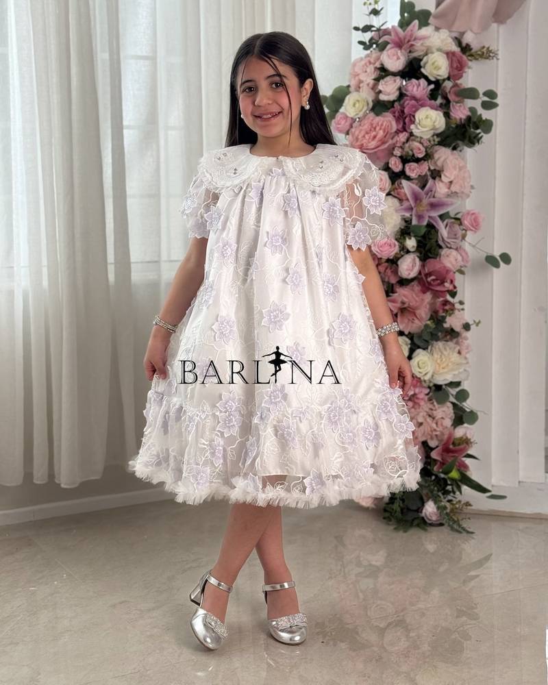 White girl's dress embroidered with purple flowers
