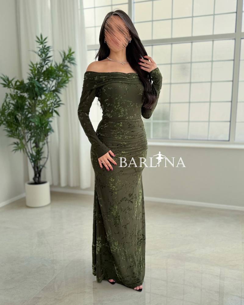 A green dress with a subtle pattern and a hint of shine.