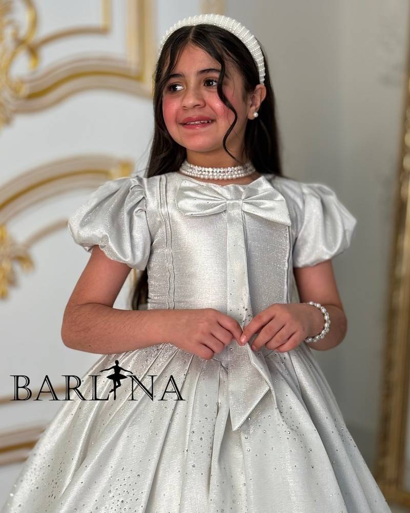 Elegant girl's dress with a bow on the chest