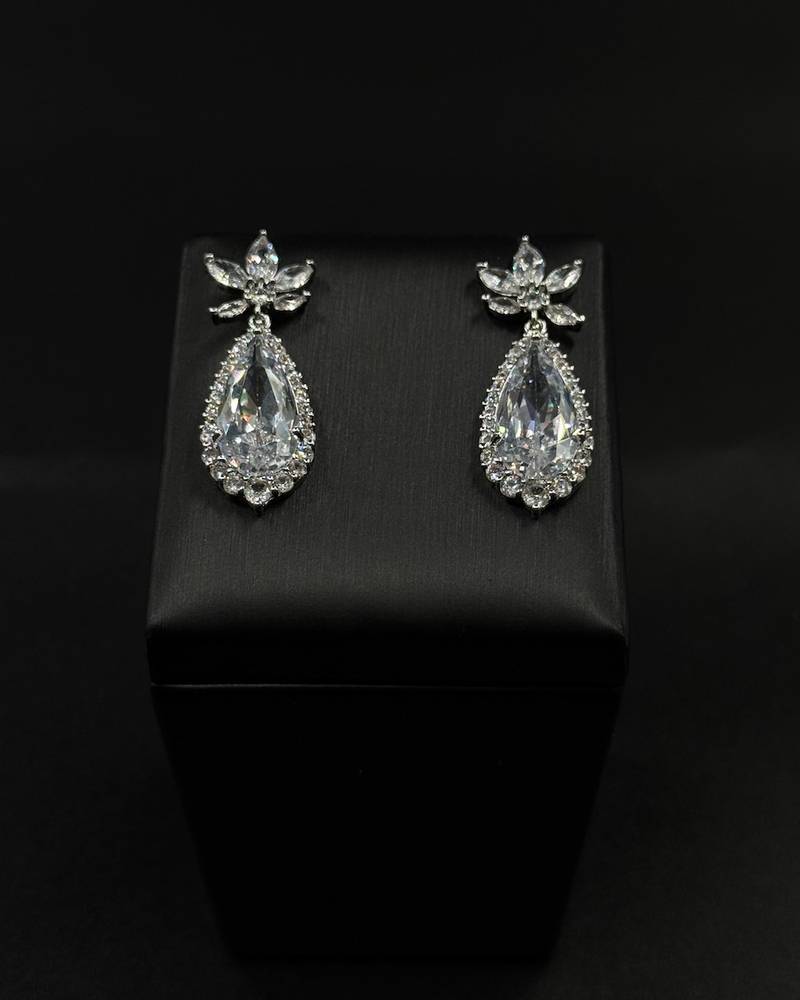 Teardrop earrings surrounded by small stones