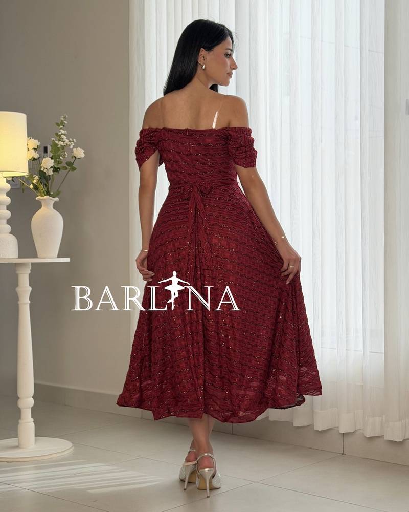 A burgundy dress with a patterned glossy fabric