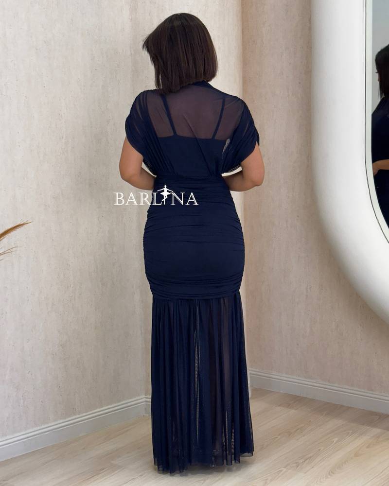 navy blue fitted dress with sheer layers at the bottom