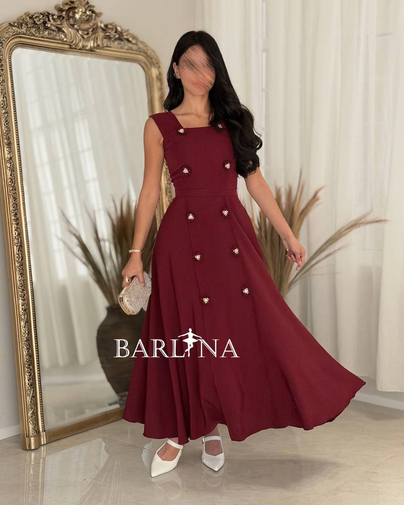 Elegant burgundy dress adorned with striking details