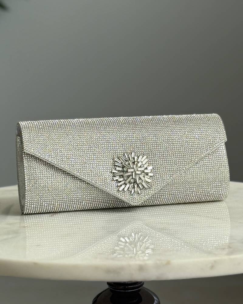 An elegant evening bag with a prominent central embellishment.