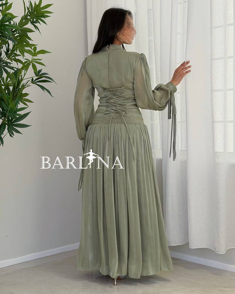 Light green pleated dress in a shiny fabric
