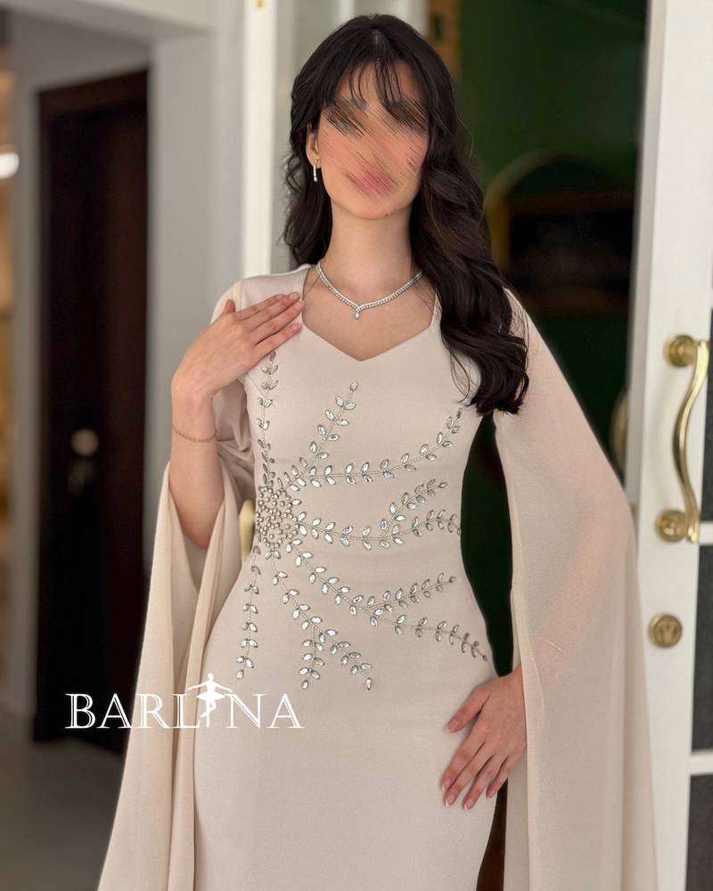 A soft off-white dress adorned with crystal embroidery