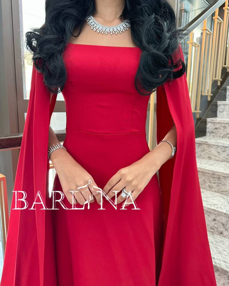 Soft red dress with long cape sleeves