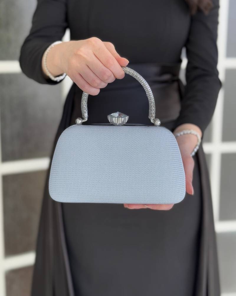 Gold evening bag with a metal frame and top lock