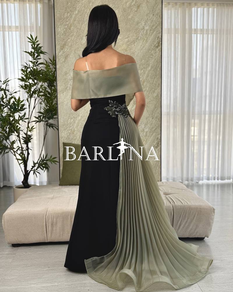 Black dress with an olive top and pleated tail