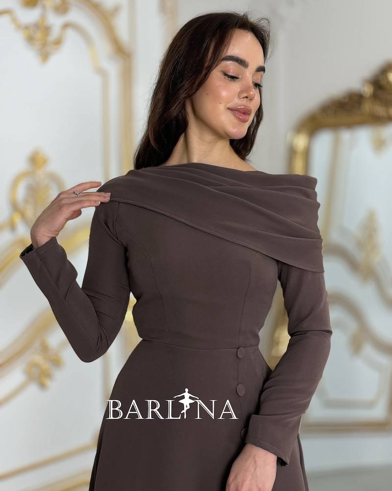A dress with a modern, elegant cut and side buttons.