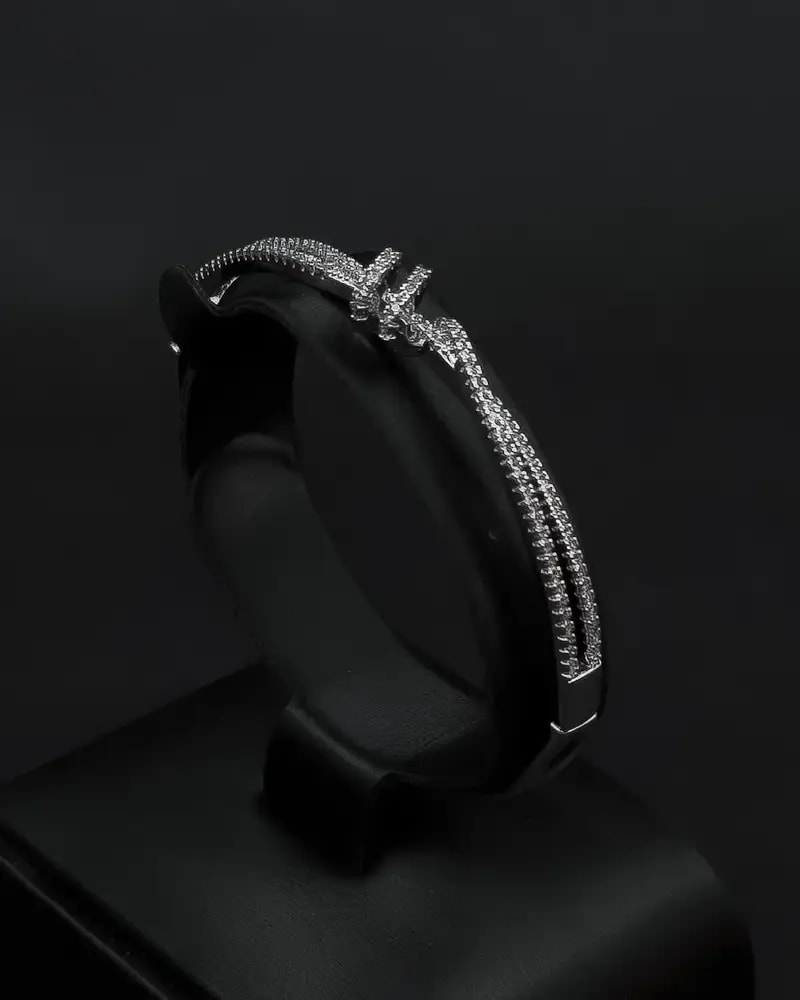 A bracelet and ring with a delicate design and prominent details.