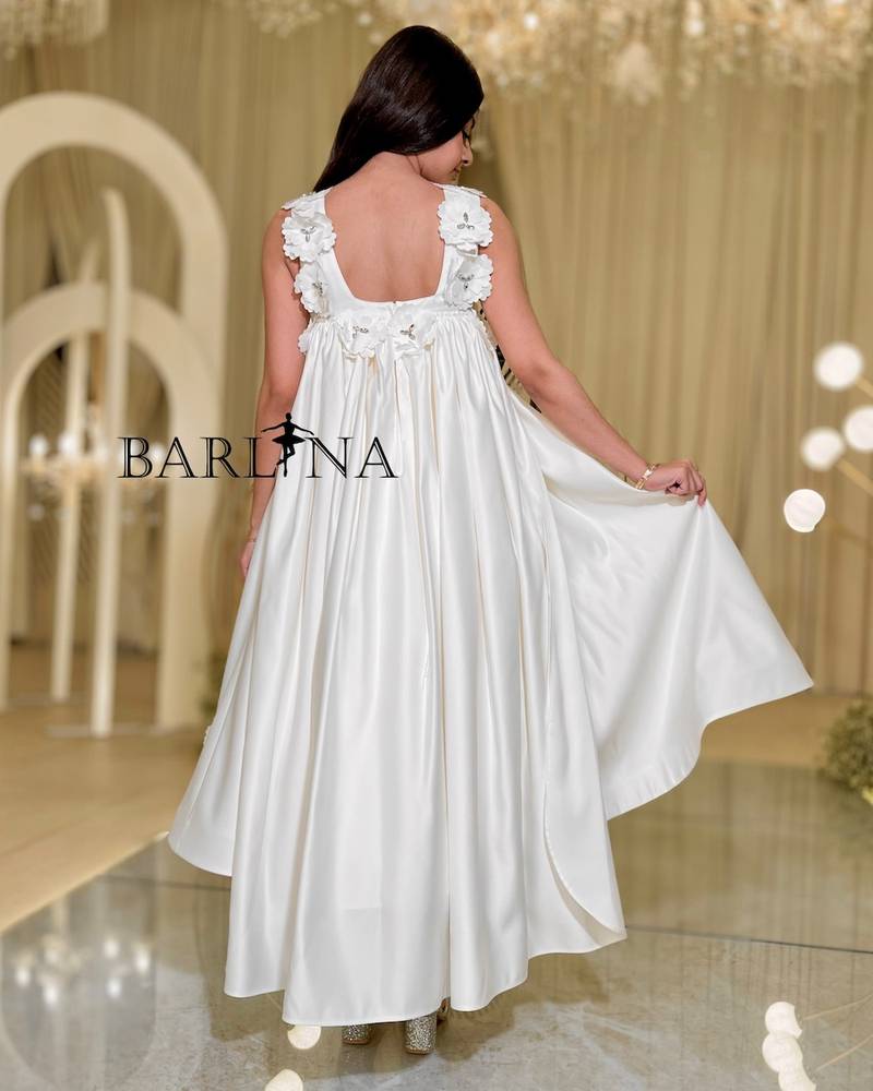 White dress with open back decorated with flowers