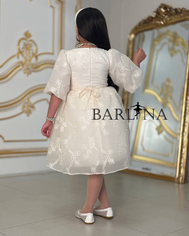 A soft, pearl-decorated girl's dress