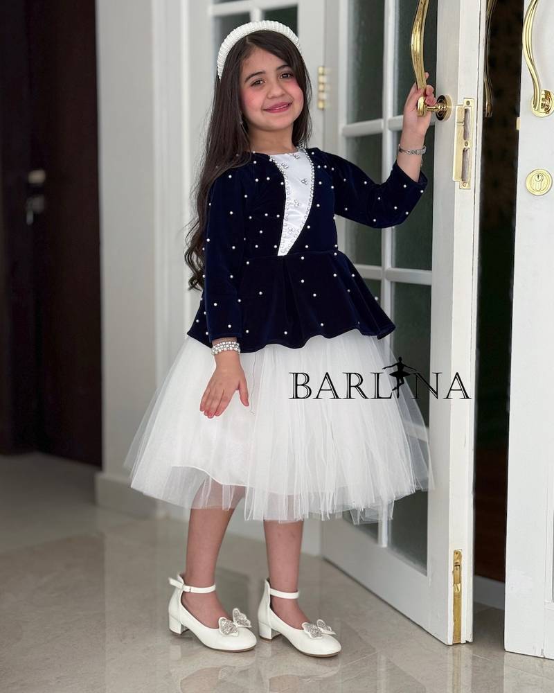 White girl's dress with a navy blue layer and crystals