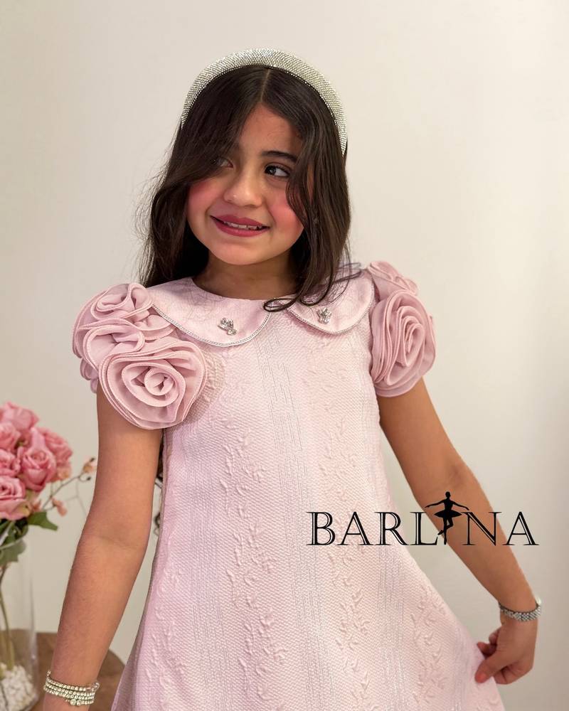 A girl's dress with a wide cut and prominent roses