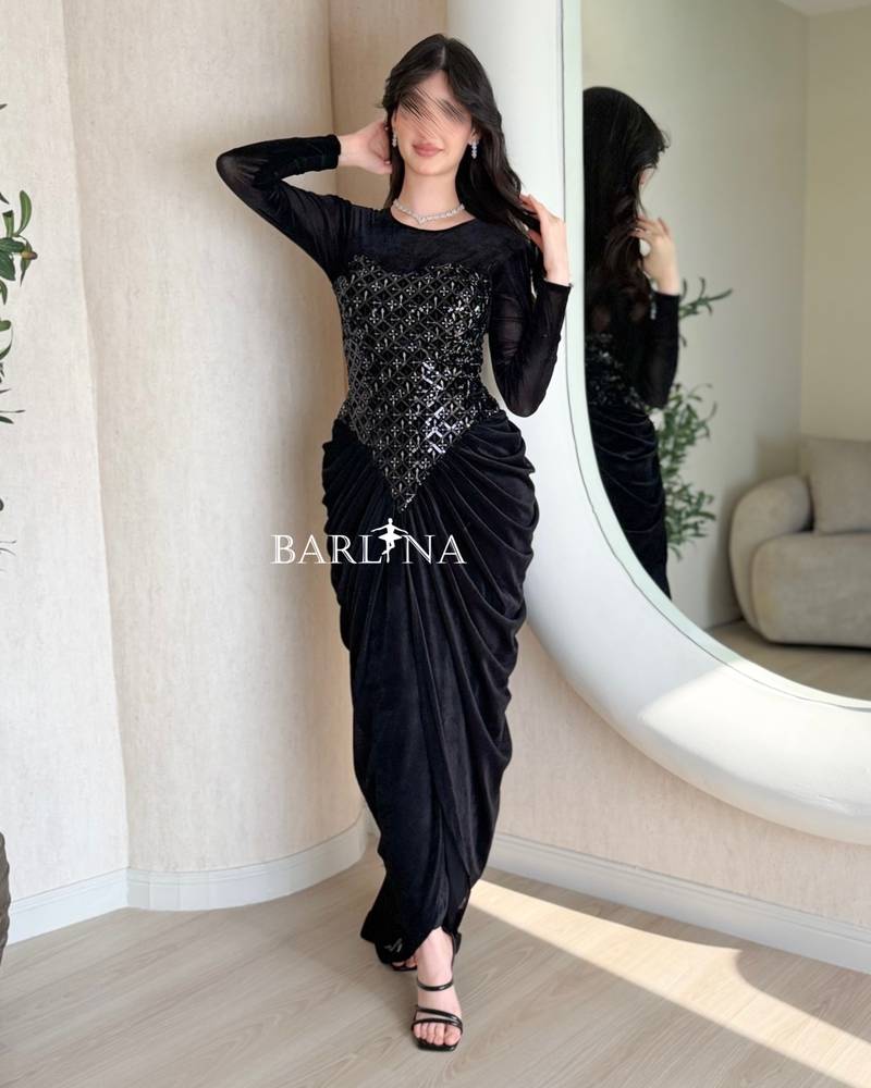 A black velvet dress with a sophisticated sheen and draping.