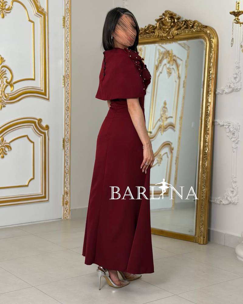 Burgundy dress with a pearl-embellished shoulder piece