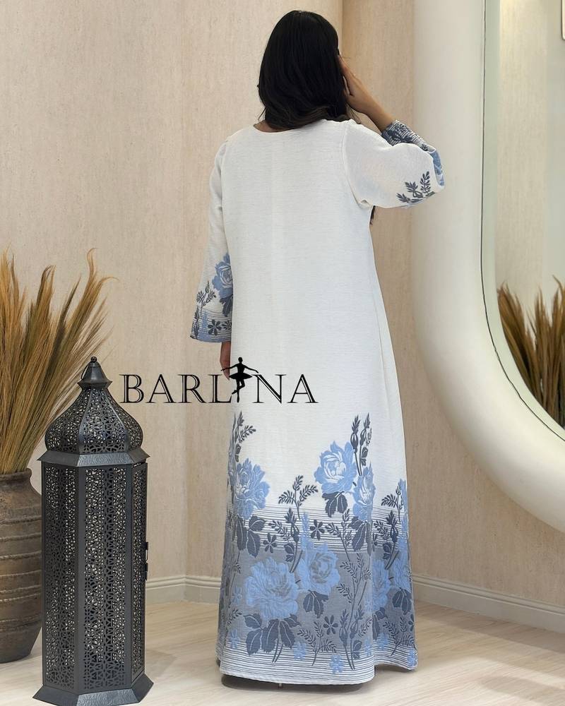 White jalabiya with a blue floral pattern