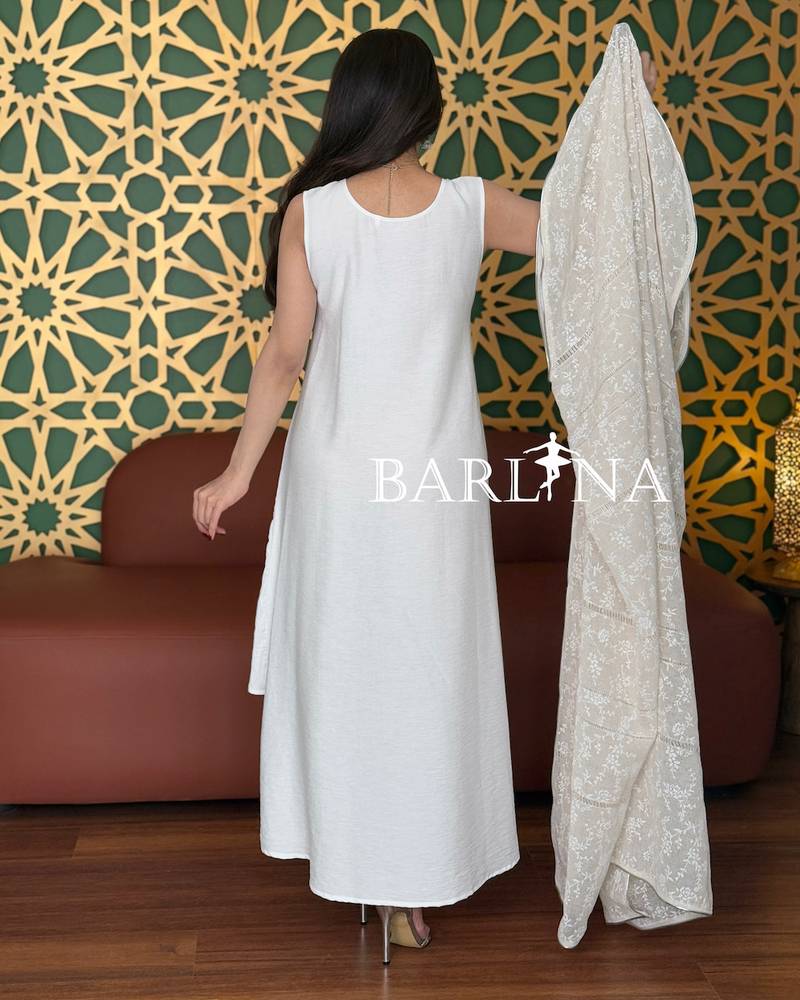 A soft white jalabiya with a sheer lace overlay.