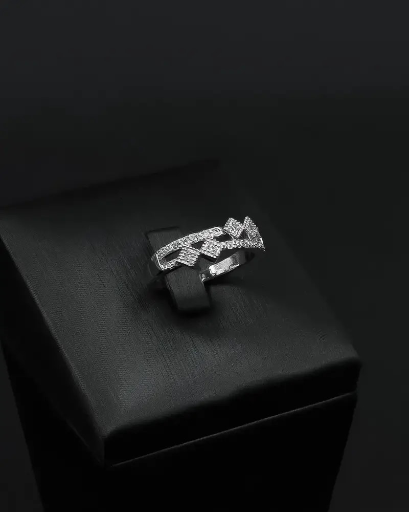 A delicate bracelet and ring with an interlocking, studded design.