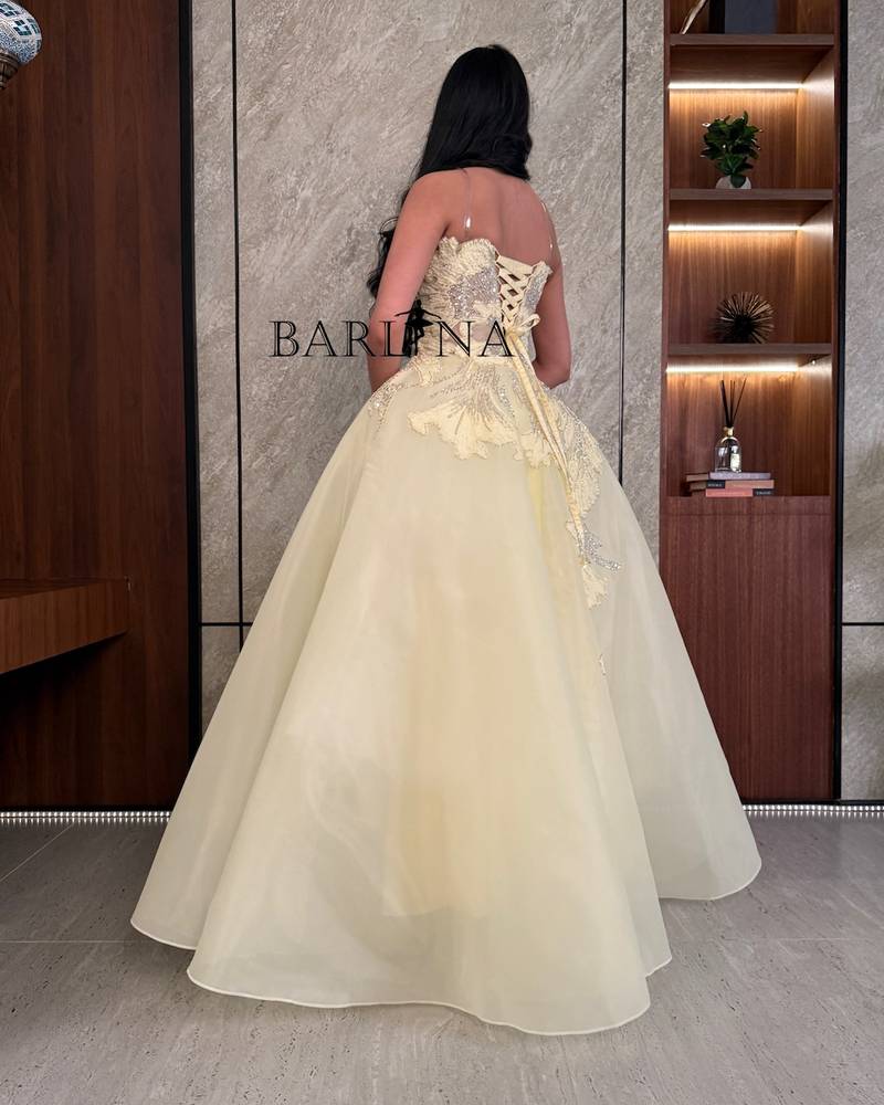 Light yellow evening dress embroidered with luxurious details