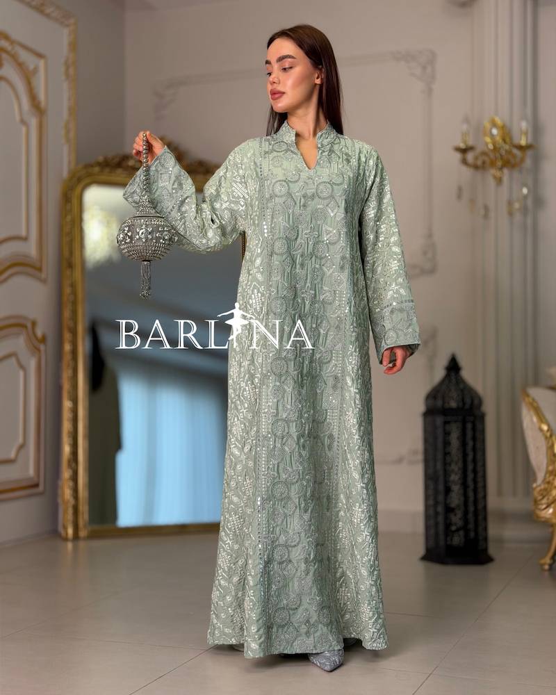 A green jalabiya decorated with full embroidery