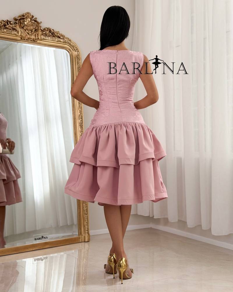 A soft dress with a low waist and layers of ruffles