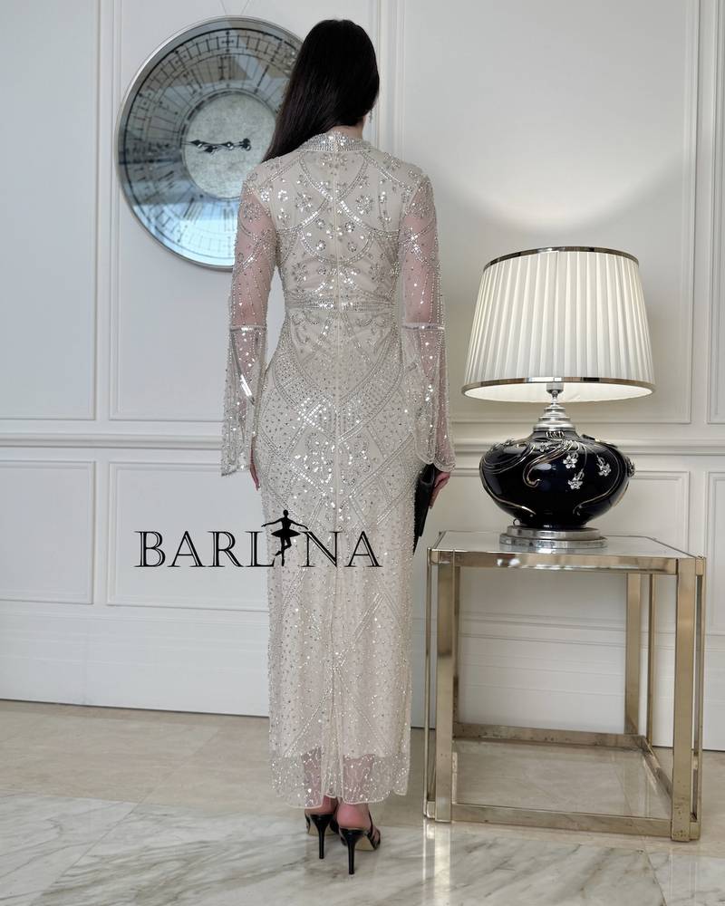 Ivory dress with sheer sleeves adorned with sequins
