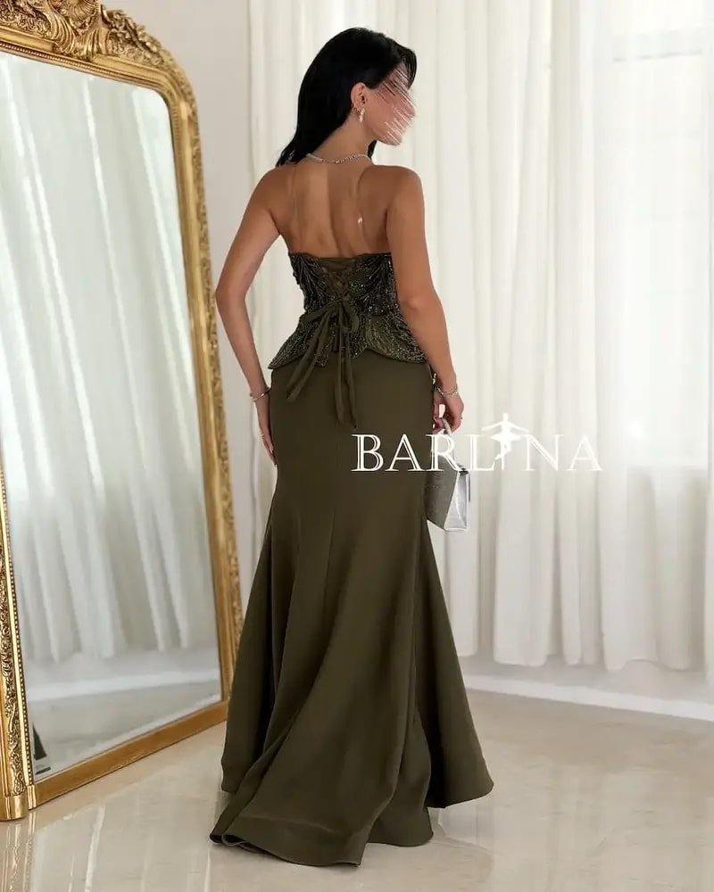 Olive green dress with prominent embroidery details