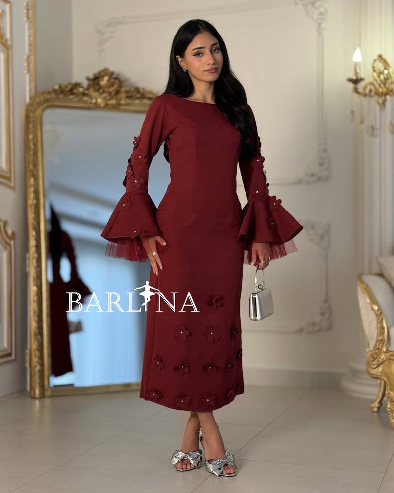 Burgundy dress with wide sleeves adorned with roses