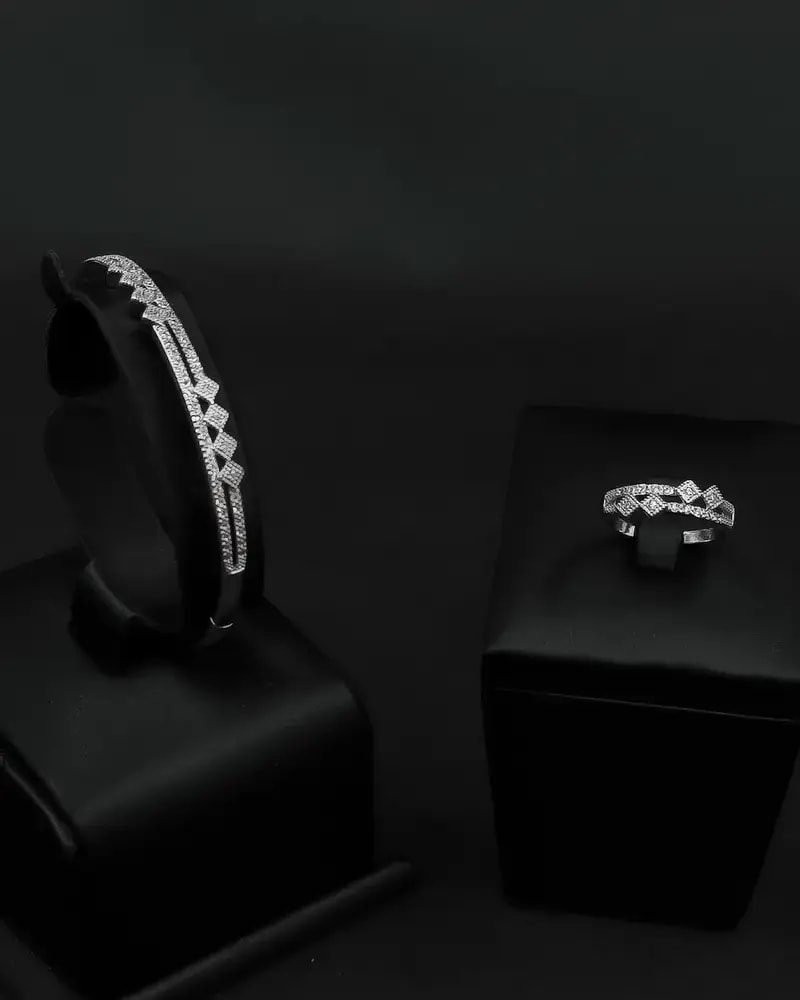 A delicate bracelet and ring with an interlocking, studded design.