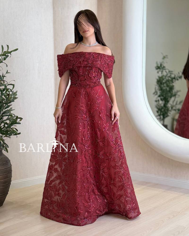 Burgundy dress with shimmering embroidery throughout the design