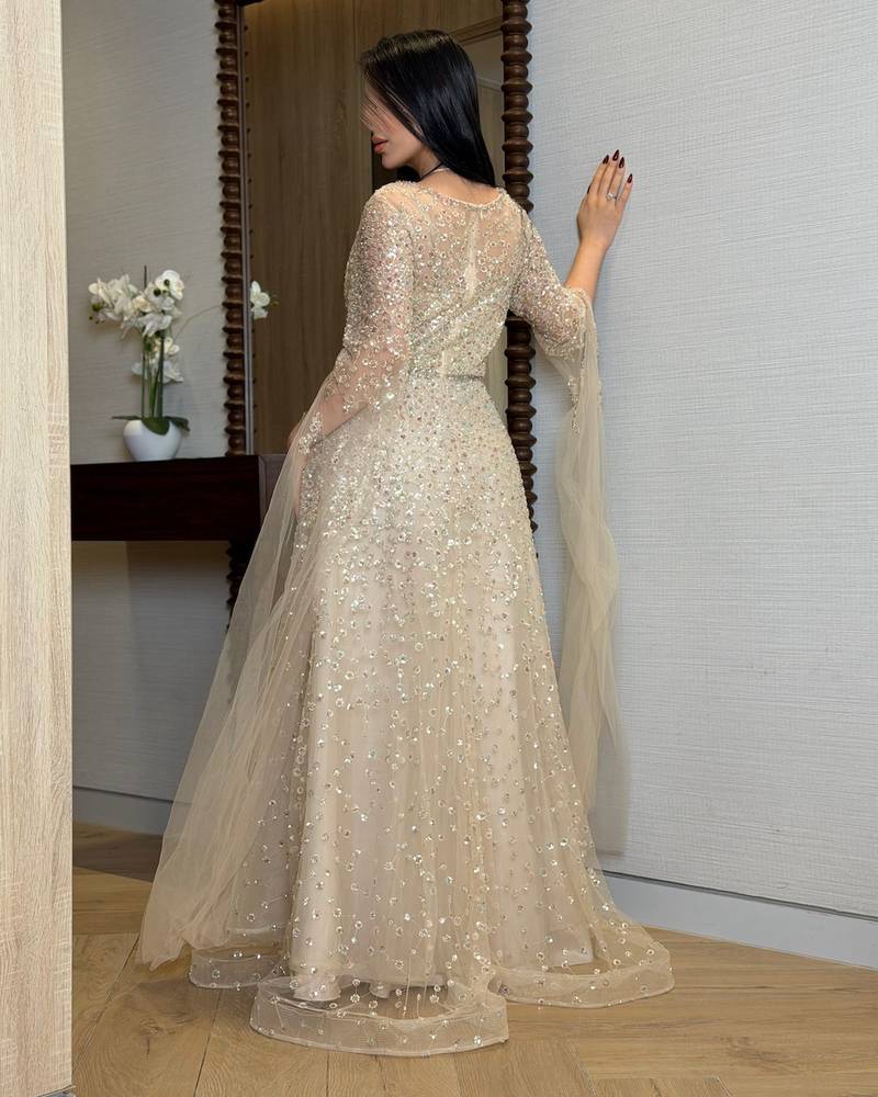 Beige evening dress with sheer draped sleeves