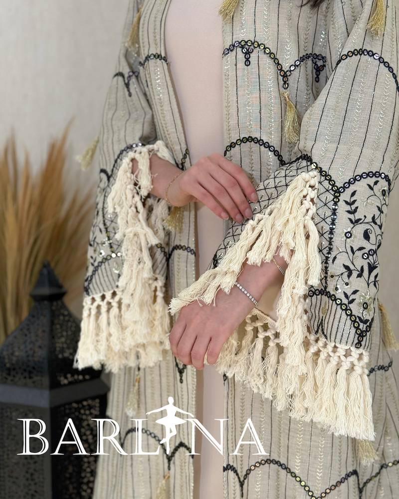 A jalabiya with a geometric pattern in shades of beige and black.