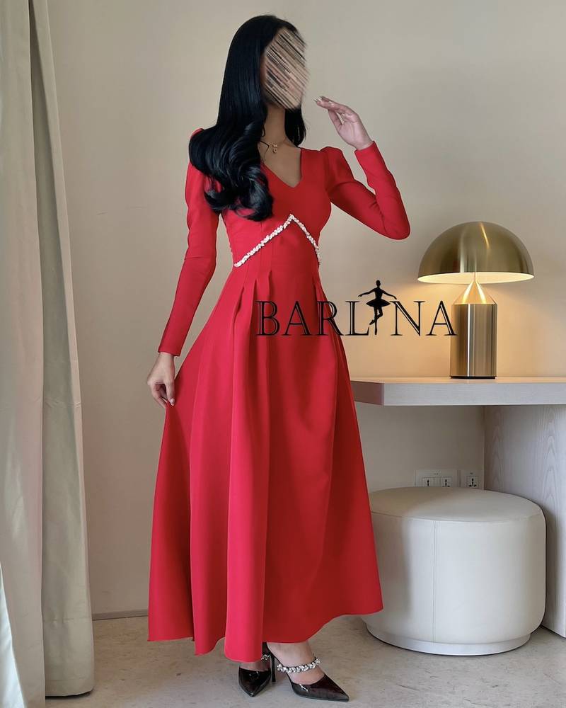 Classic red dress decorated with crystals with long sleeves