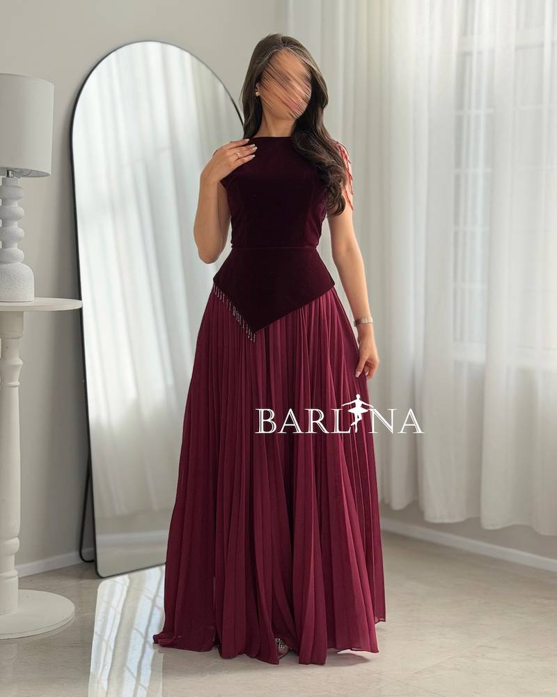 A burgundy dress with a velvet top and a slanted waist.