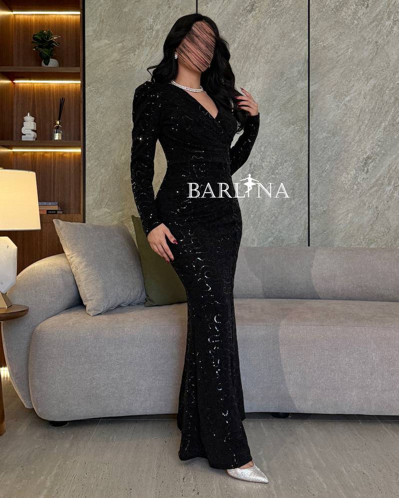 Black embroidered dress with shiny touches and a side slit