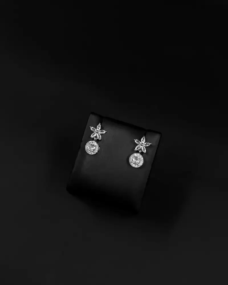 Floral stud earrings with a circular pendant