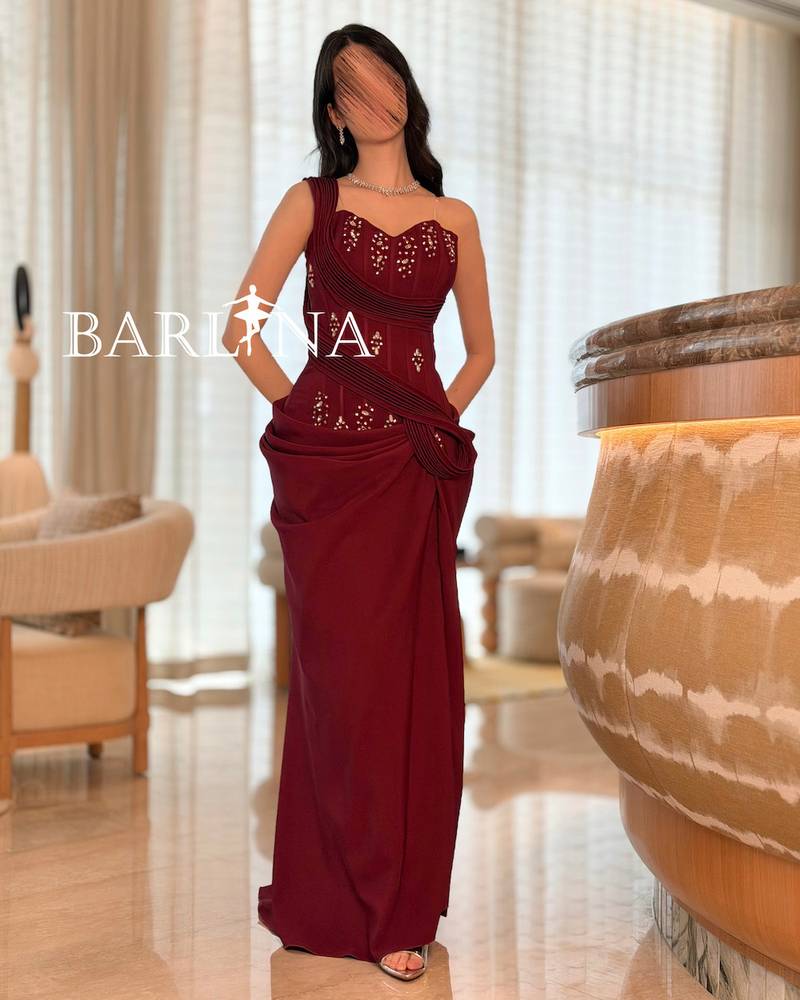 Burgundy dress with shimmering embroidery and draped design