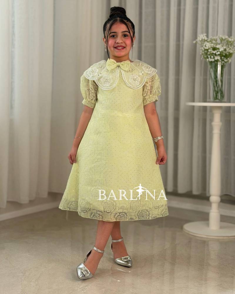A yellow girl's dress with elegant and sophisticated details