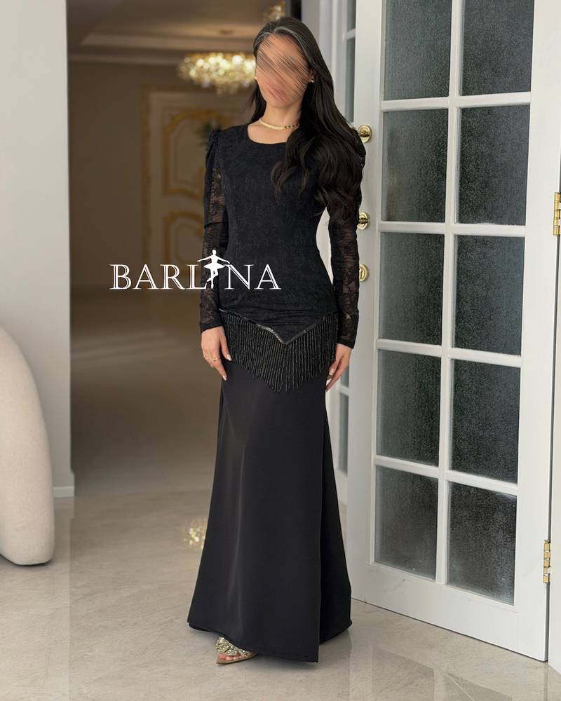 A soft black dress with lace and fringe details